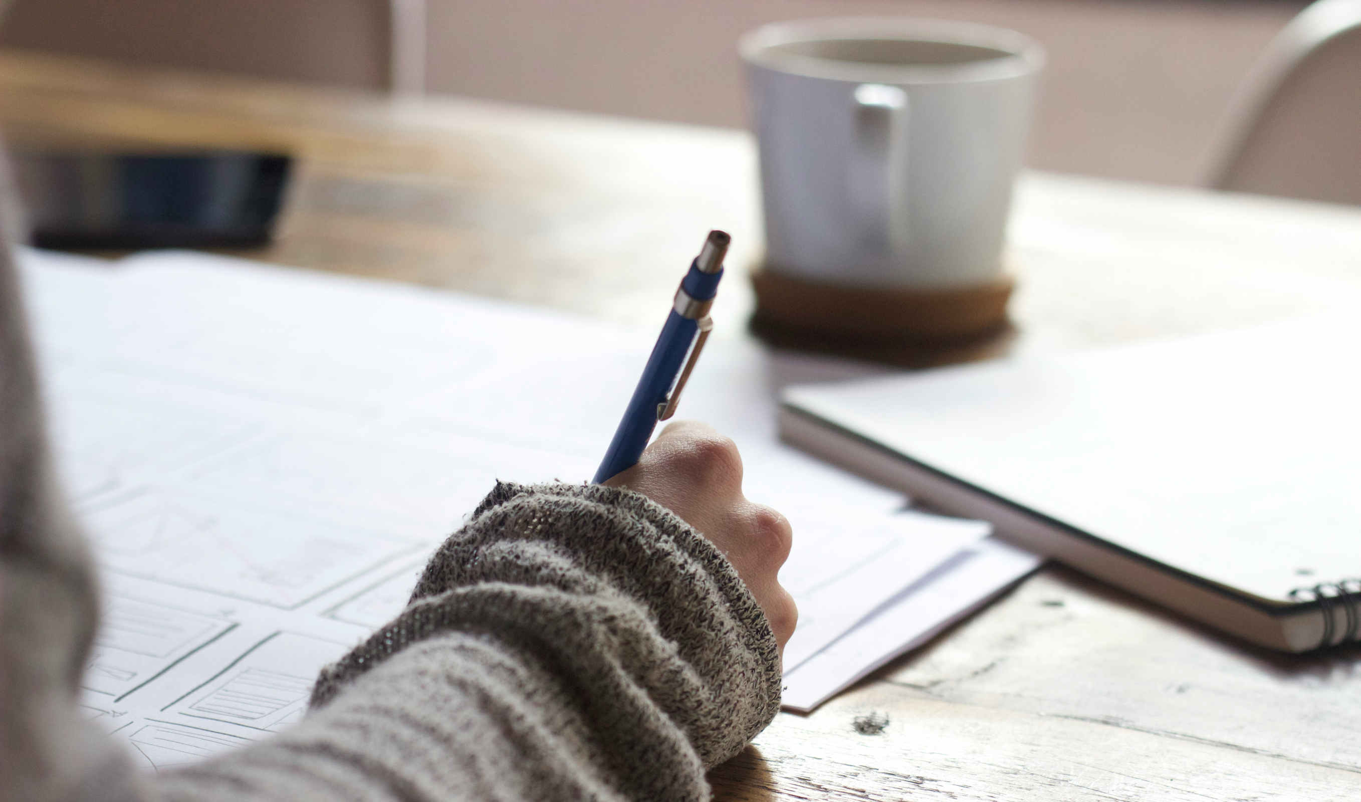 person writing with a pen